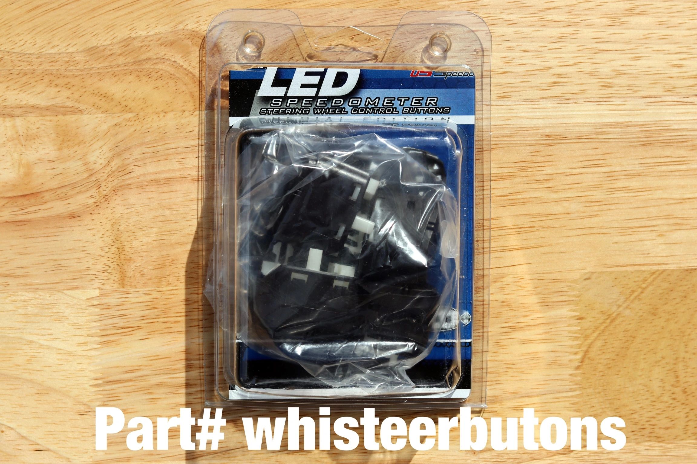 LED car accessory packaging on wooden table.