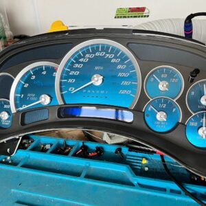 Blue automotive instrument cluster on table