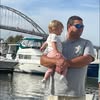 Man holding child by the marina